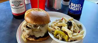 Slippery Noodle Inn signature dishes The Firecracker Burger, 10 oz Ribeye, Chicken Parmesan, The Blue Hen, The Triple Decker Club